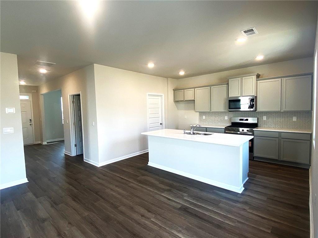 97 Defilippe Drive Statham, GA 30666 - Photo 7 of 58 a kitchen with stainless steel appliances granite countertop a stove a sink and a refrigerator