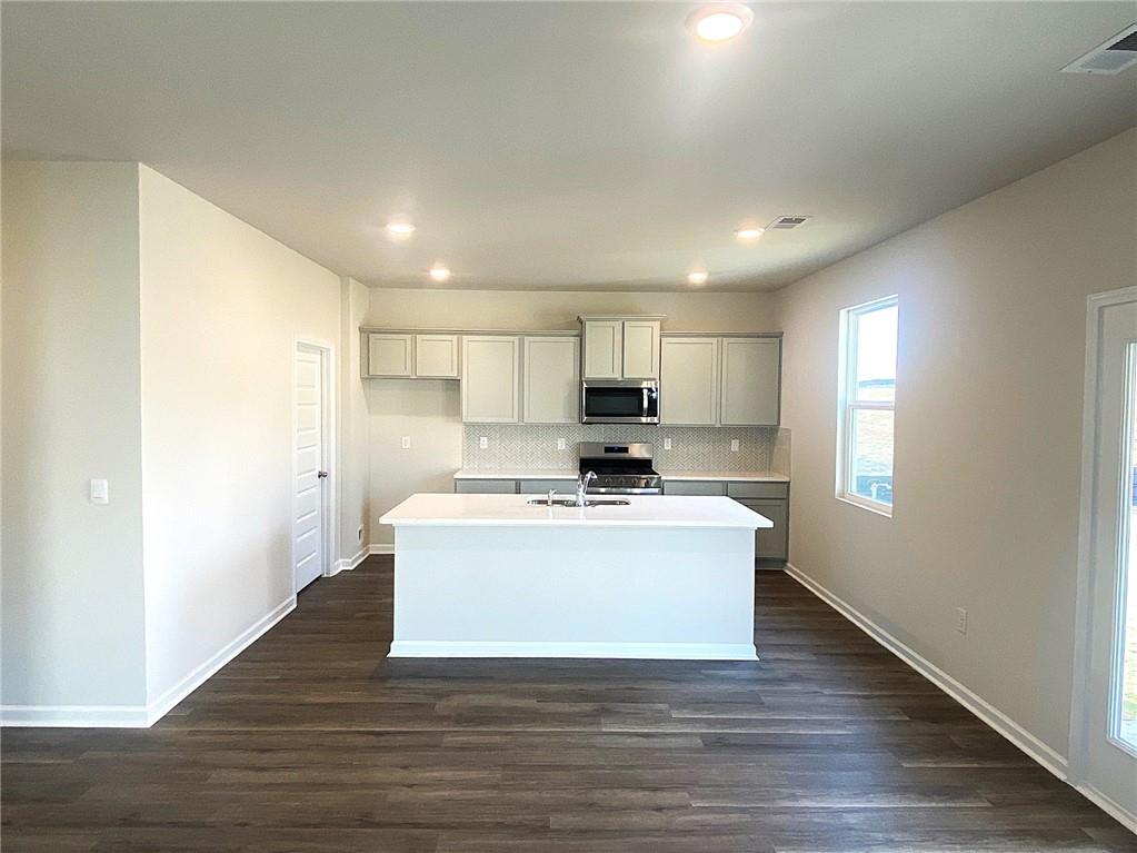 97 Defilippe Drive Statham, GA 30666 - Photo 8 of 58 a view of kitchen with microwave stove refrigerator and cabinets