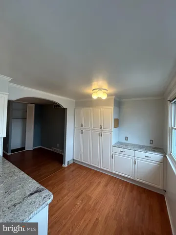 a view of a kitchen with wooden floor and a sink