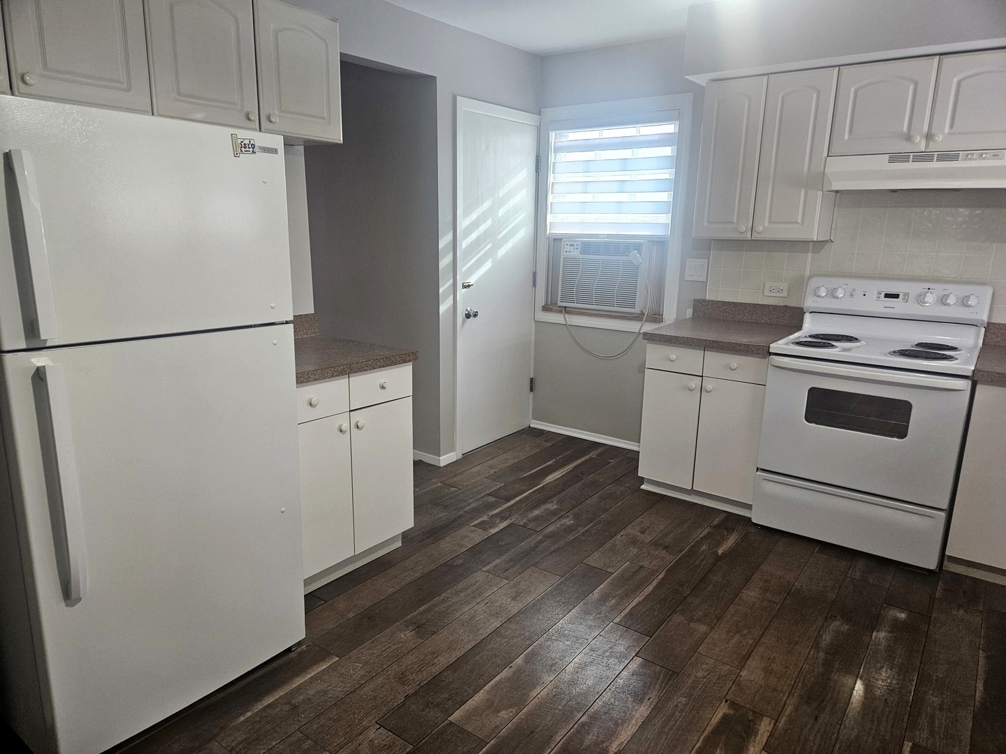863 North Northwest Highway, Unit 2 Park Ridge, IL 60068 - Photo 12 of 23 a white refrigerator freezer sitting inside of a kitchen with stainless steel appliances wooden floor