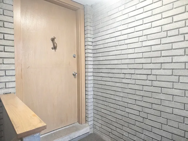 an entryway of a room with windows