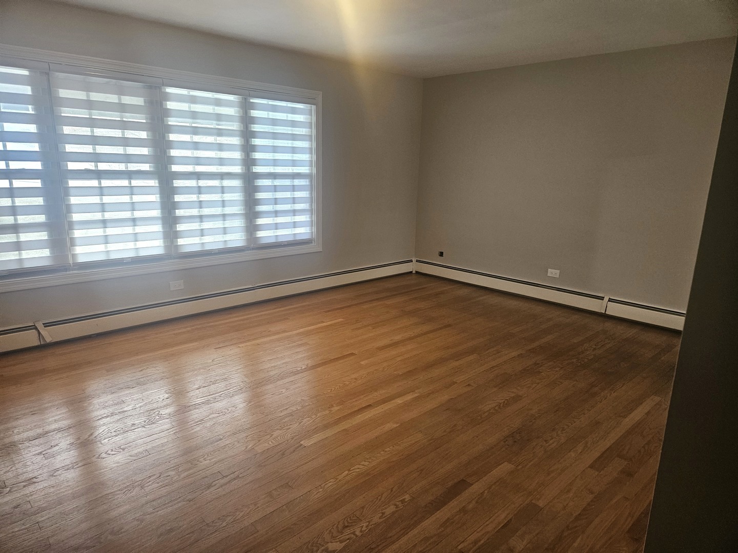 863 North Northwest Highway, Unit 2 Park Ridge, IL 60068 - Photo 10 of 23 a view of an empty room with wooden floor and a window