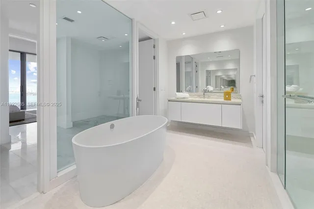 a bathroom with a bathtub and shower