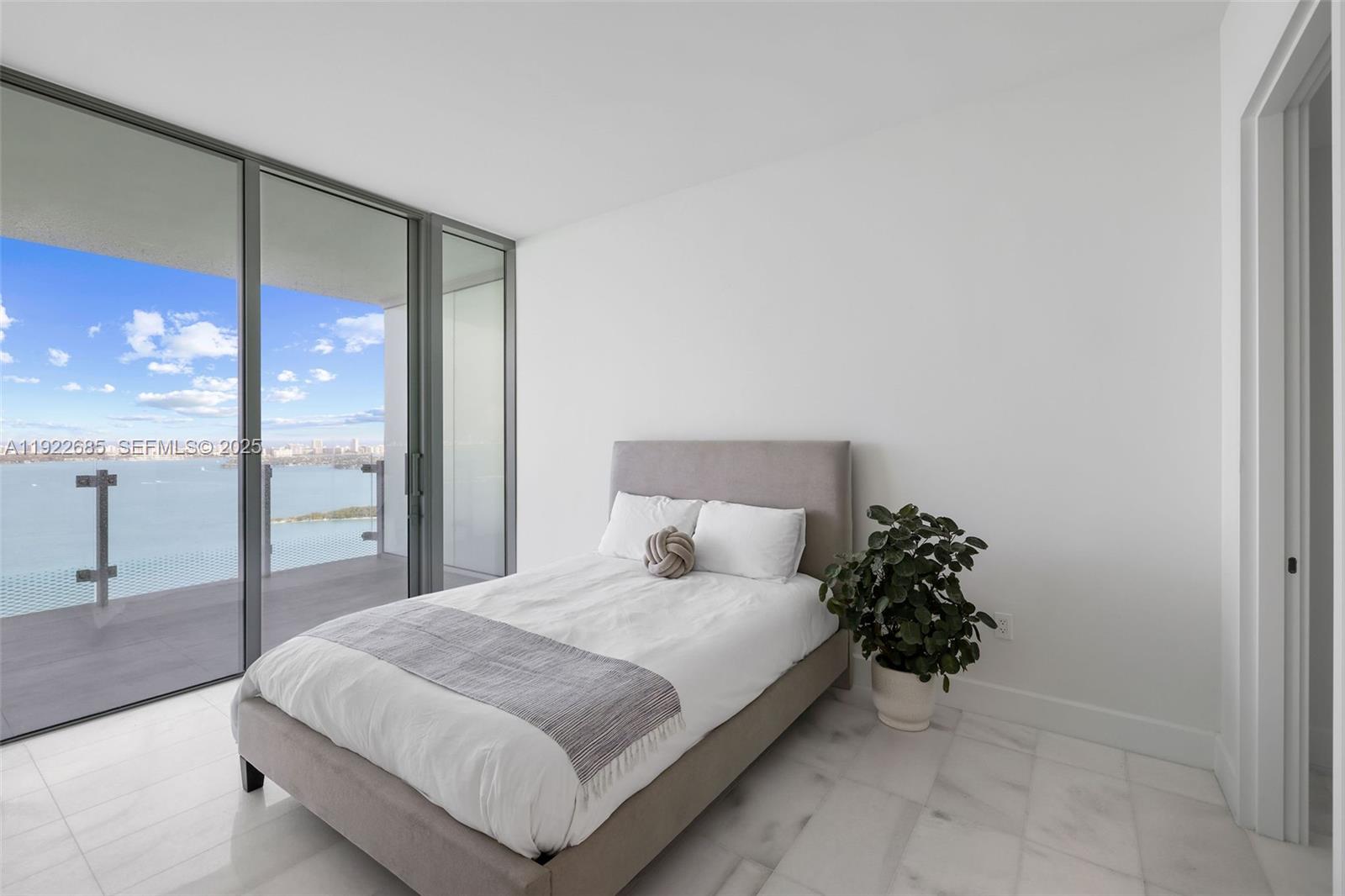 700 Northeast 26th Terrace, Unit 3602 Miami, FL 33137 - Photo 16 of 42 a bedroom with a bed and a large window