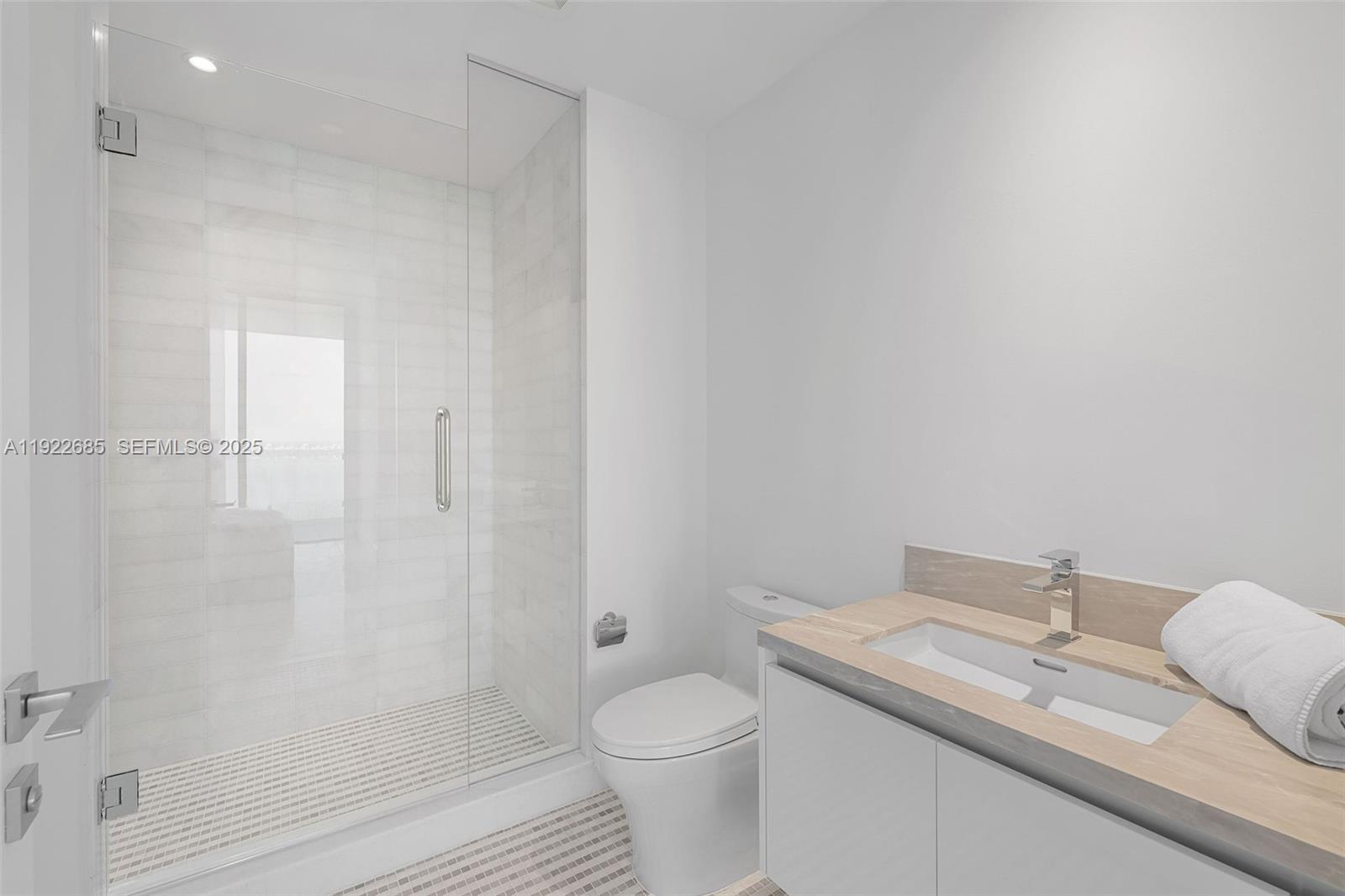 700 Northeast 26th Terrace, Unit 3602 Miami, FL 33137 - Photo 18 of 42 a bathroom with a granite countertop sink a toilet and shower