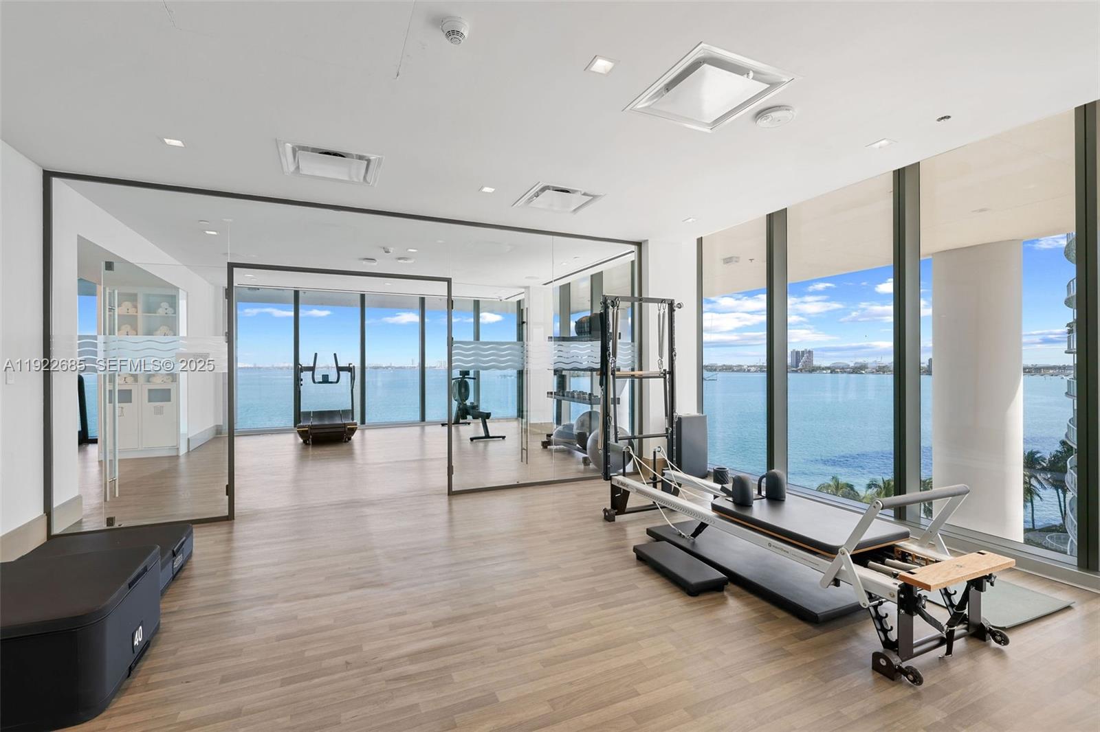 700 Northeast 26th Terrace, Unit 3602 Miami, FL 33137 - Photo 31 of 42 a view of a room with gym equipment and floor to ceiling window