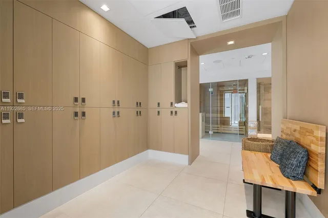 a bathroom with a granite countertop sink a mirror and shower