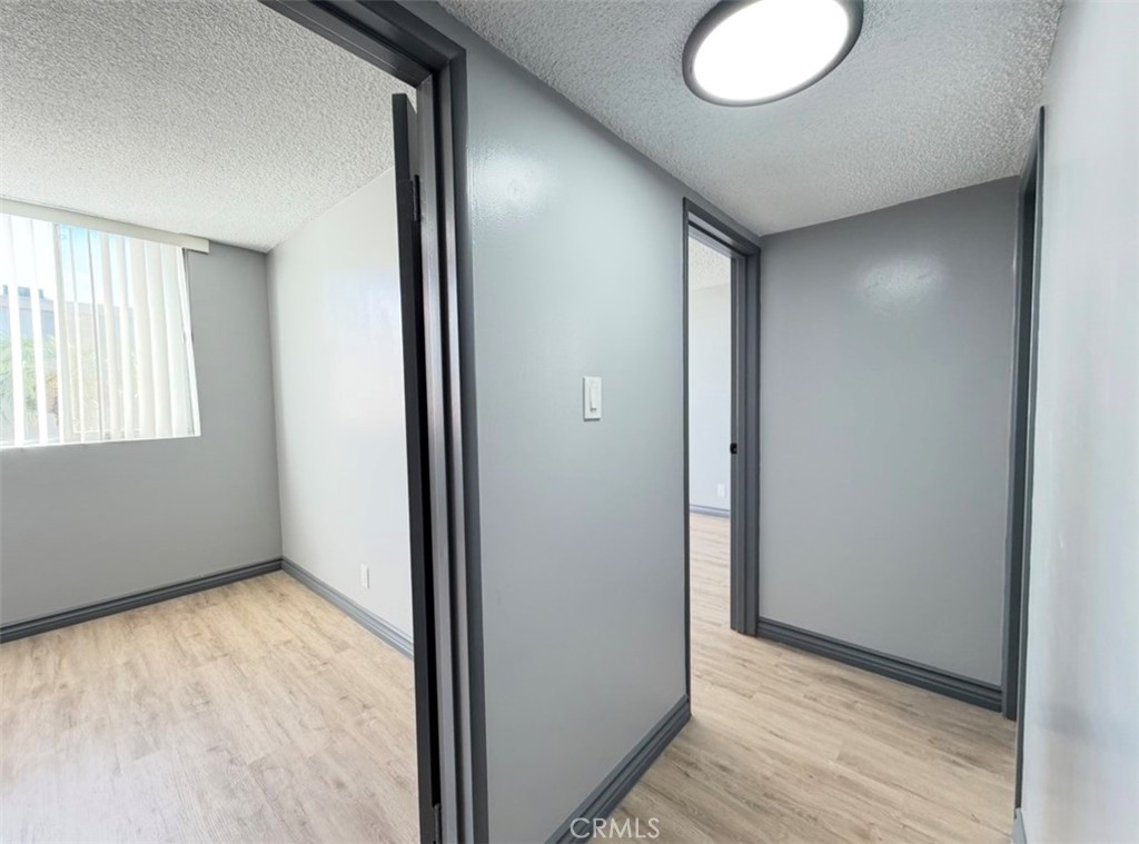 6979 Palm Court, Unit N242 Riverside, CA 92506 - Photo 14 of 27 an empty room with wooden floor and windows