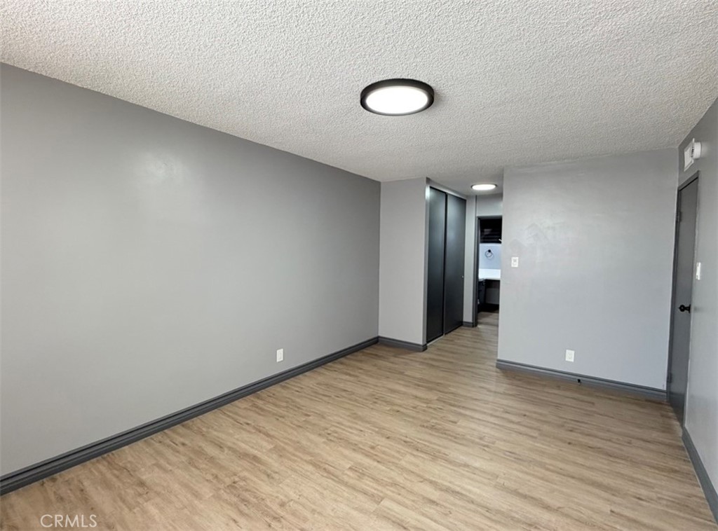 6979 Palm Court, Unit N242 Riverside, CA 92506 - Photo 16 of 27 a view of an empty room and wooden floor