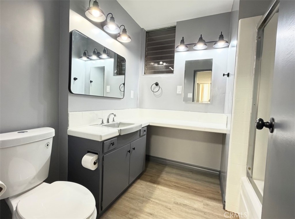 6979 Palm Court, Unit N242 Riverside, CA 92506 - Photo 18 of 27 a bathroom with a toilet sink and mirror