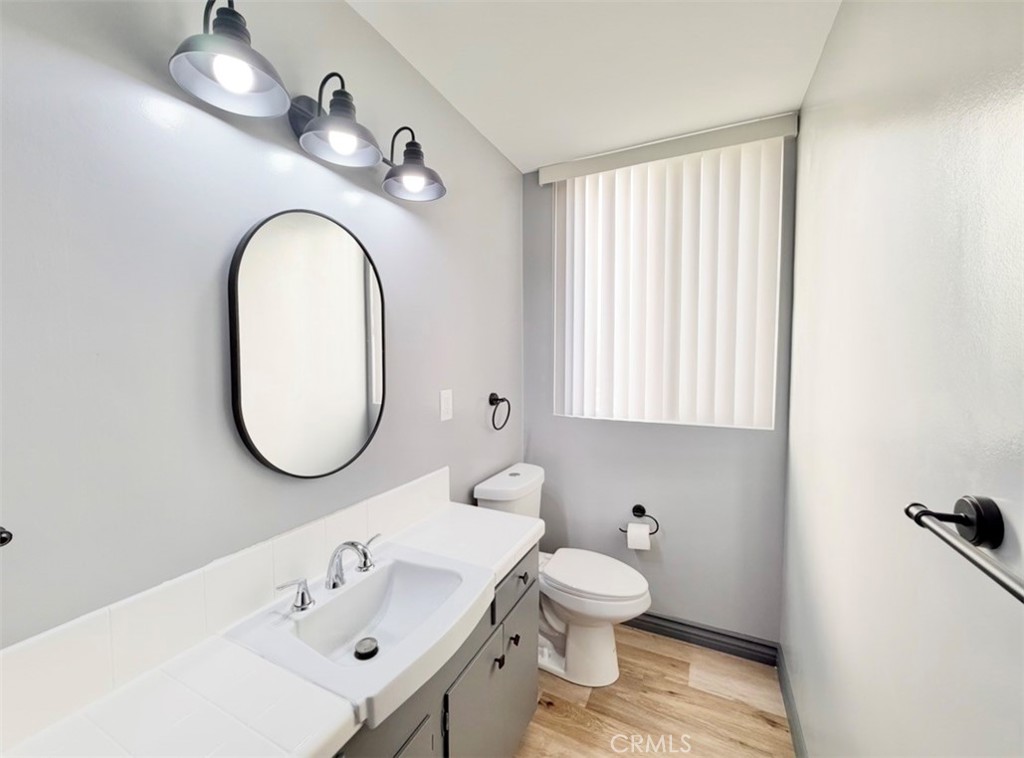 6979 Palm Court, Unit N242 Riverside, CA 92506 - Photo 21 of 27 a bathroom with a sink a toilet and a mirror