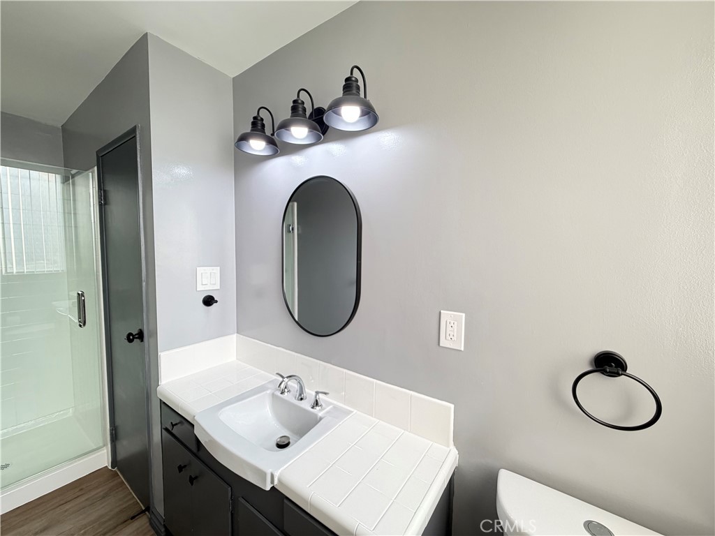 6979 Palm Court, Unit N242 Riverside, CA 92506 - Photo 22 of 27 a bathroom with a toilet a sink and mirror