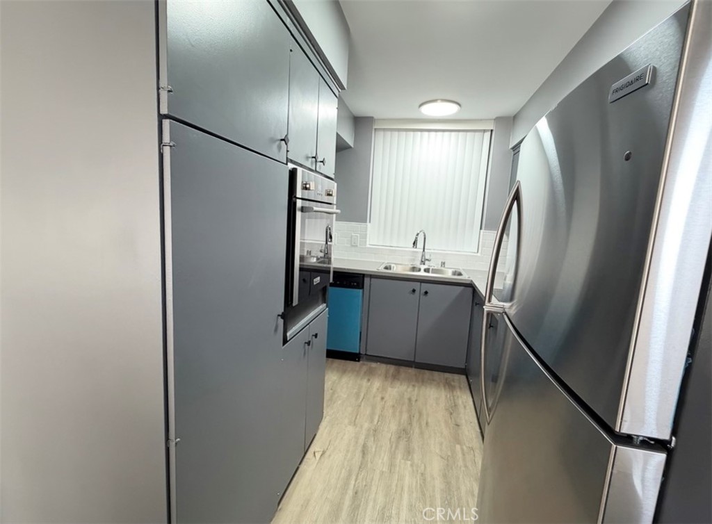 6979 Palm Court, Unit N242 Riverside, CA 92506 - Photo 3 of 27 a kitchen with stainless steel appliances a refrigerator and a sink