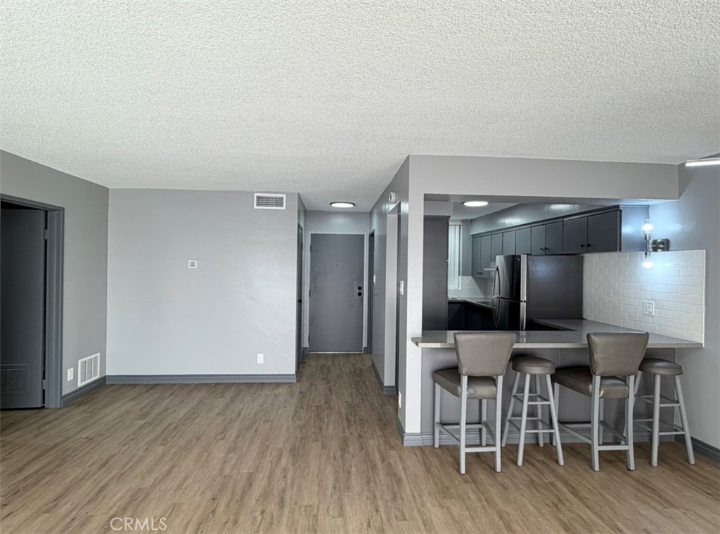 6979 Palm Court, Unit N242 Riverside, CA 92506 - Photo 8 of 27 a view of kitchen with furniture and wooden floor