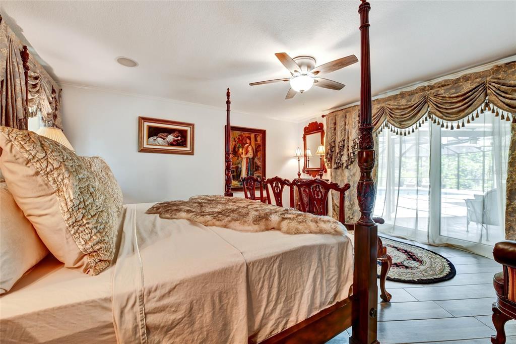 1875 Belleair Road Clearwater, FL 33764 - Photo 30 of 100 a bedroom with a bed and dresser with wooden floor