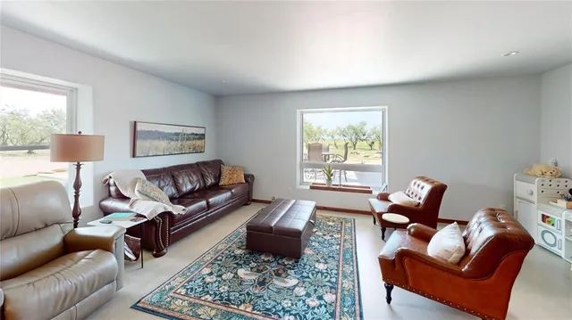 a living room with furniture a couch and a window