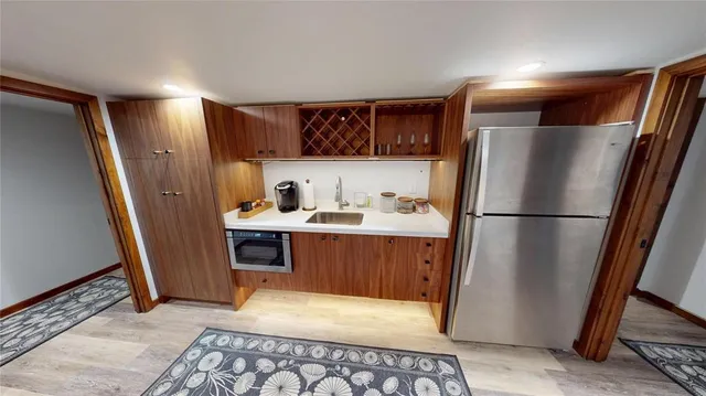 a kitchen with stainless steel appliances a refrigerator a sink a stove a microwave and cabinets