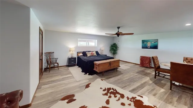 a bedroom with furniture and a wooden floor