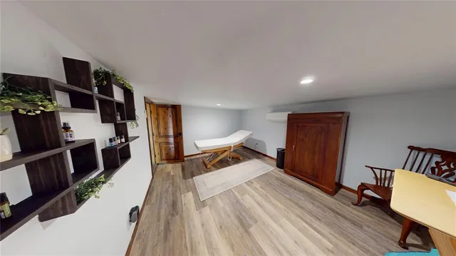 a bedroom with furniture and a wooden floor