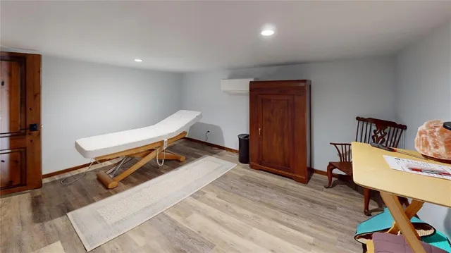 a room with wooden floor and furniture