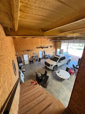 a view of a balcony with chairs and wooden floor