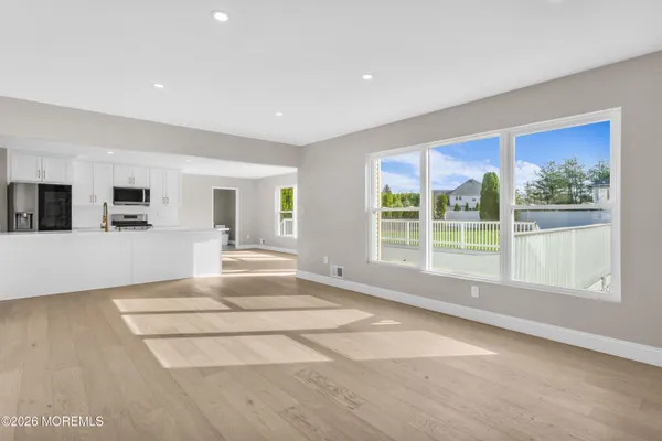 a open kitchen with stainless steel appliances granite countertop a stove and a sink