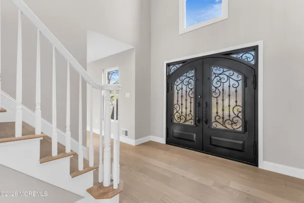 a view of a room with window wooden floor and chandelier