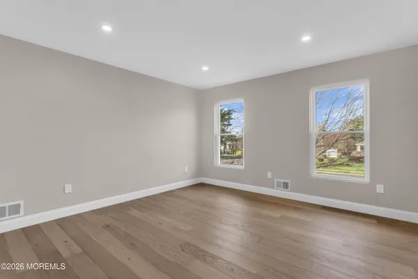 a view of room with wooden floor