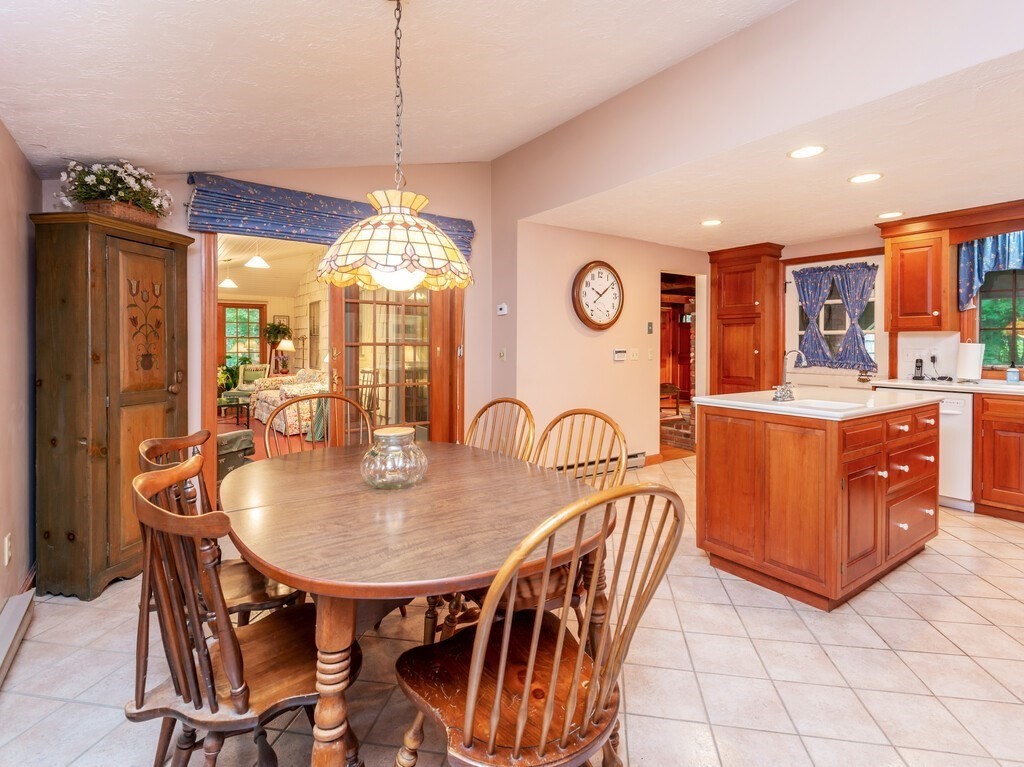 17 Wells Park Road Sturbridge, MA 01566 - Photo 13 of 37 a dining room filled chandelier and wooden furniture