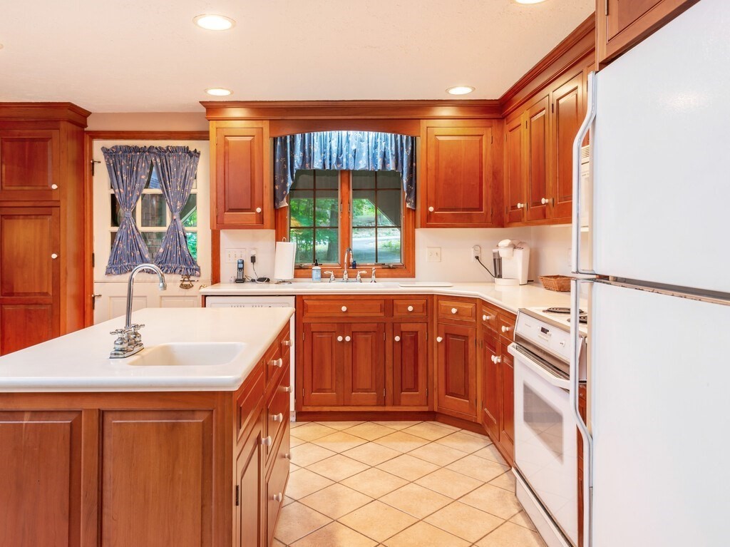 17 Wells Park Road Sturbridge, MA 01566 - Photo 9 of 37 a kitchen with stainless steel appliances granite countertop a sink stove and refrigerator