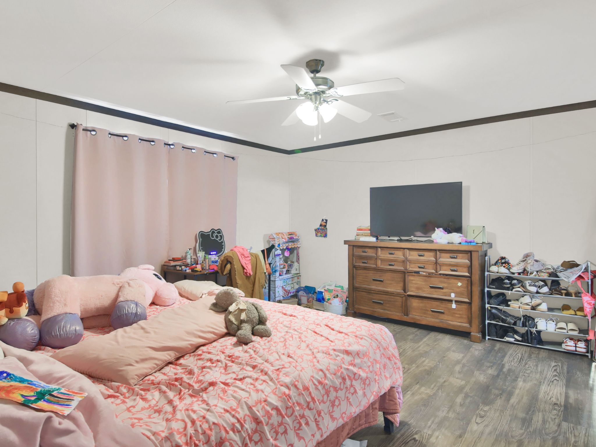 271 Alma Lane Kyle, TX 78640 - Photo 16 of 25 a bedroom with a bed and a flat tv screen on dresser