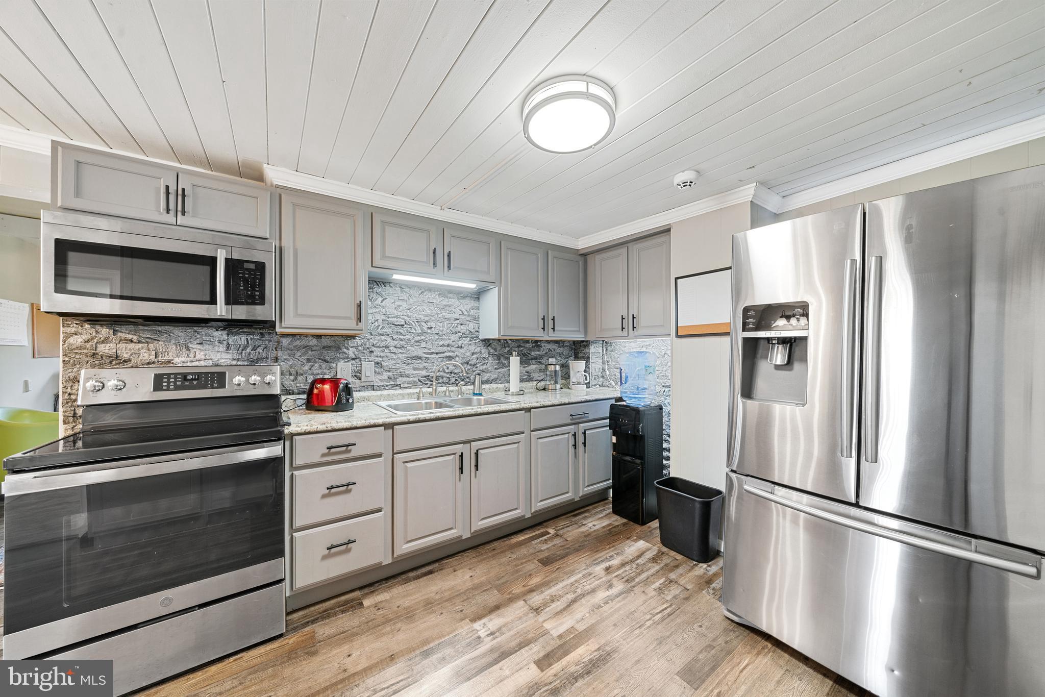 962 Wadesville Road Berryville, VA 22611 - Photo 27 of 63 a kitchen with stainless steel appliances a refrigerator sink and microwave