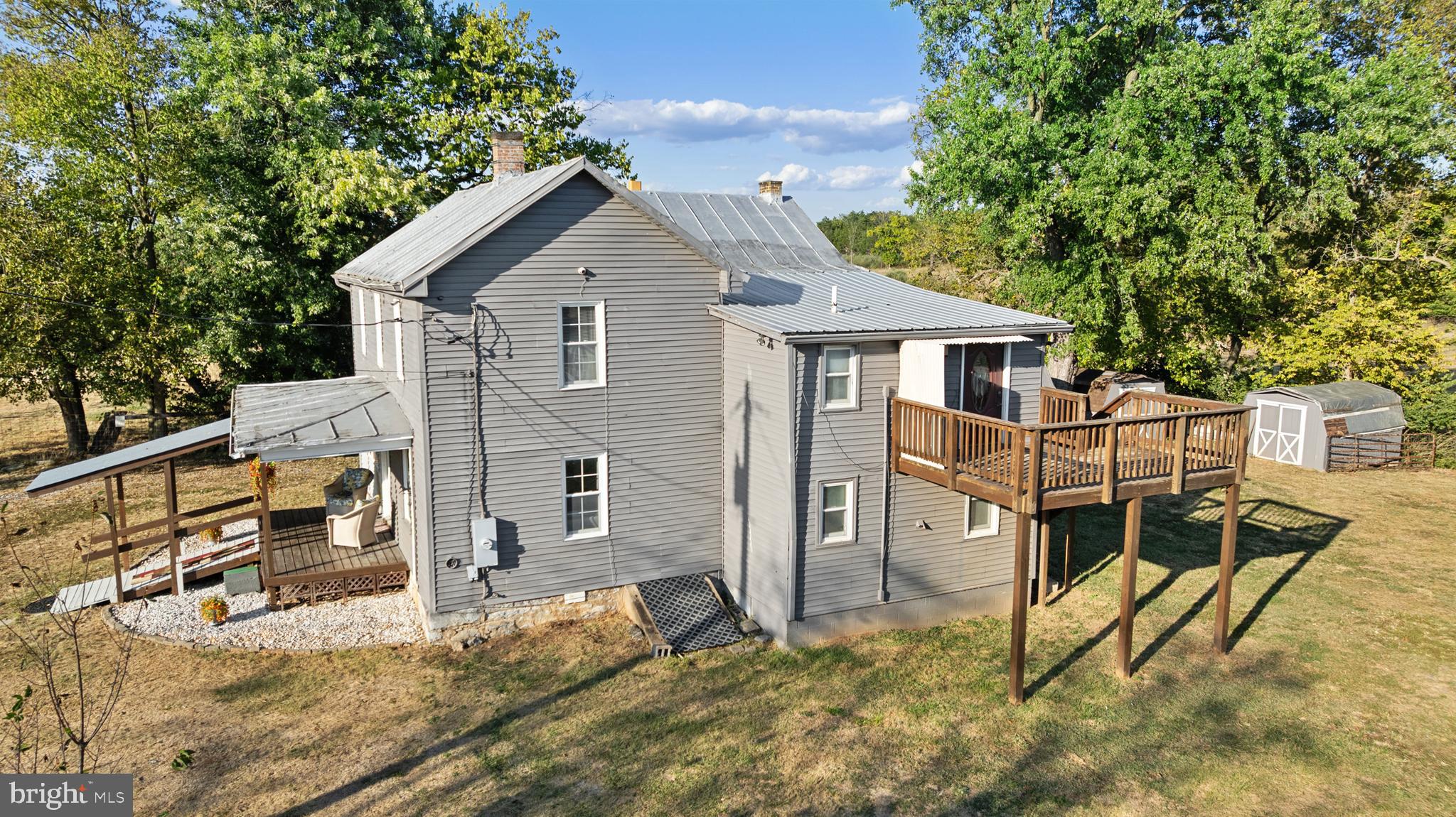 962 Wadesville Road Berryville, VA 22611 - Photo 31 of 63 a view of a house with wooden walls and a large tree