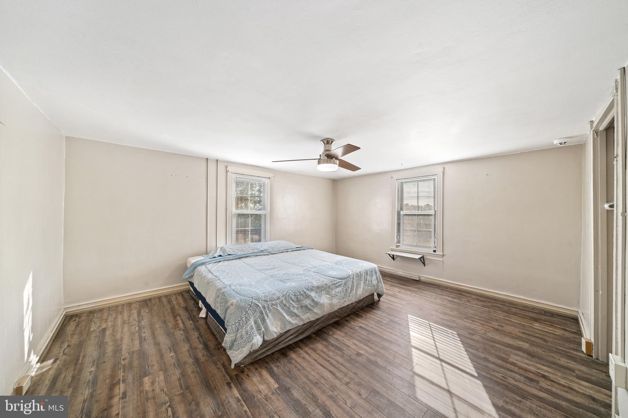 962 Wadesville Road Berryville, VA 22611 - Photo 39 of 63 a spacious bedroom with a bed and wooden floor