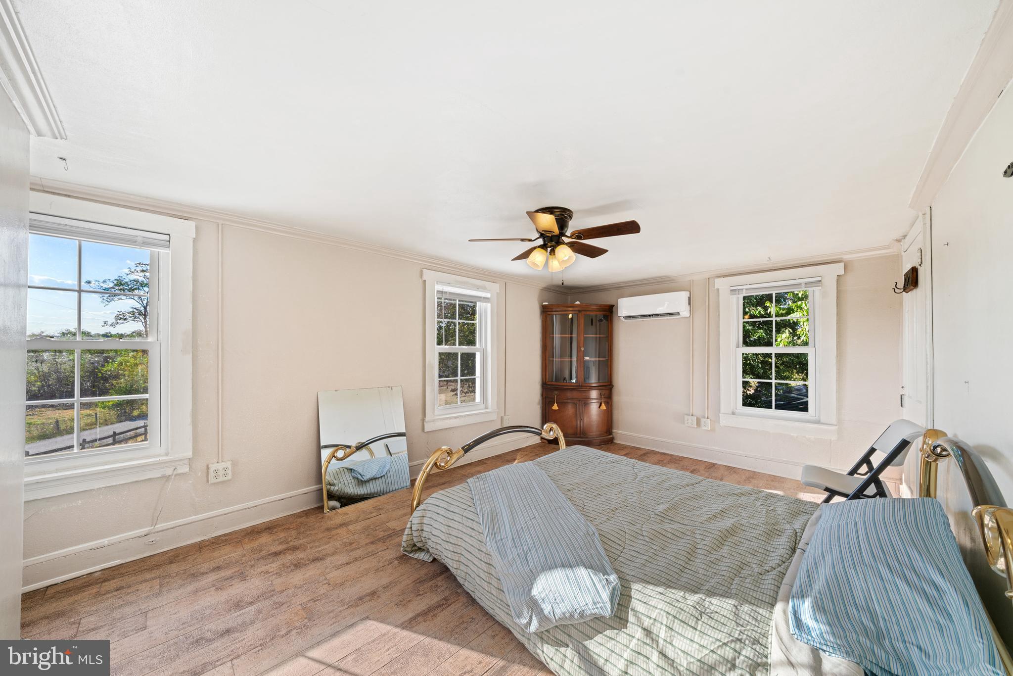 962 Wadesville Road Berryville, VA 22611 - Photo 40 of 63 a spacious bedroom with a bed a dresser and windows