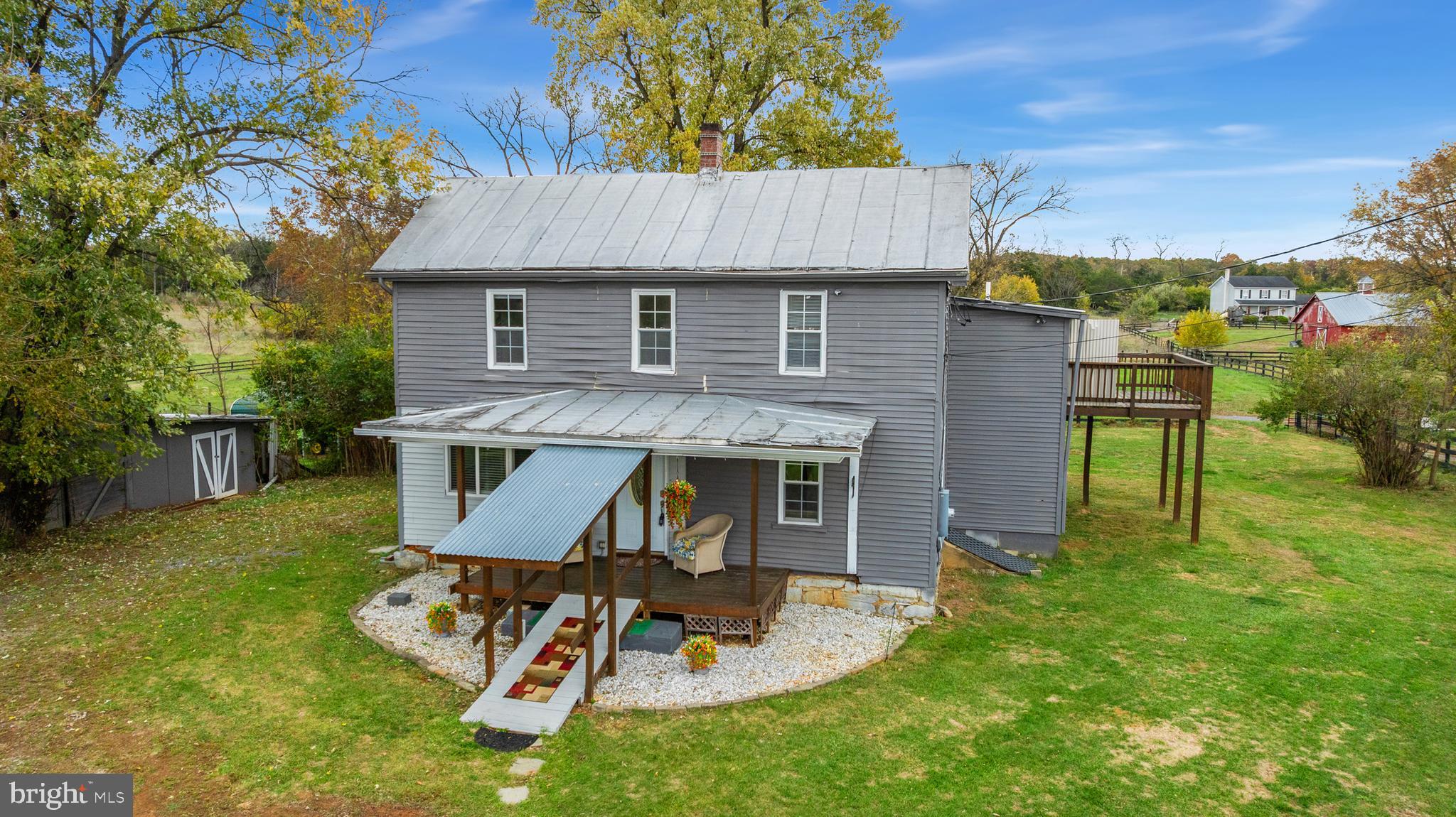 962 Wadesville Road Berryville, VA 22611 - Photo 50 of 63 a aerial view of a house with table and chairs in patio