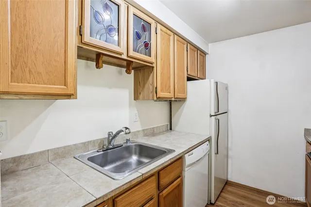 a kitchen with a sink and a refrigerator