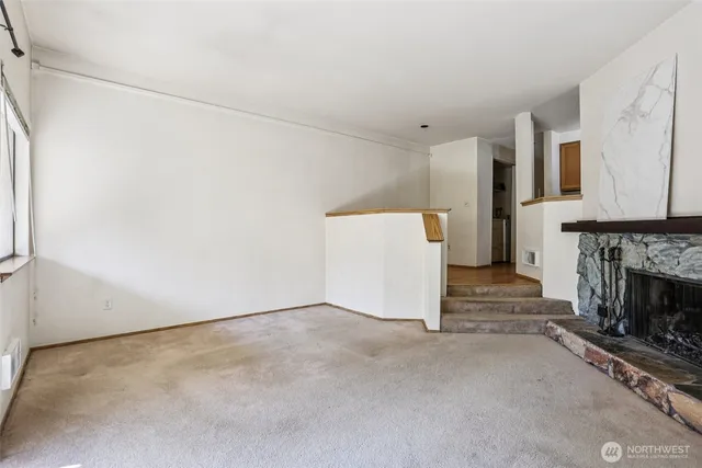 a view of a room with furniture and a fireplace