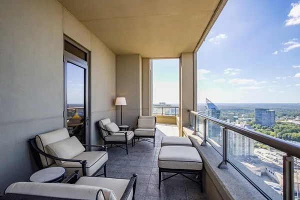 a living room with furniture and floor to ceiling windows