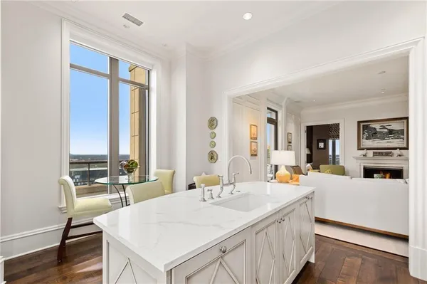 a large white kitchen with a large window