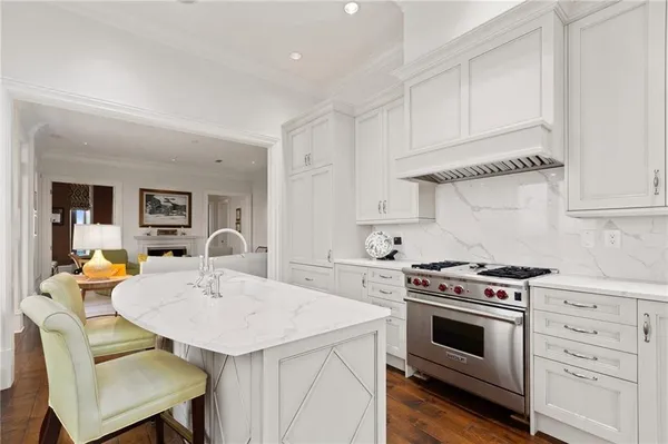 a kitchen with a stove a table and chairs