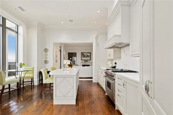 a large kitchen with a table and chairs