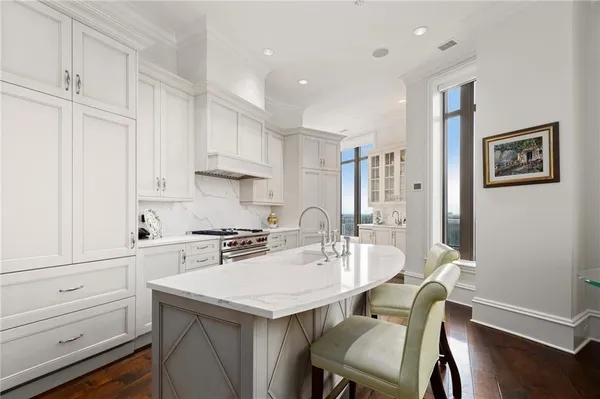 a kitchen with a sink cabinets and wooden floor