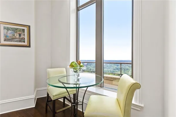 a view of a dining room with a table and chairs