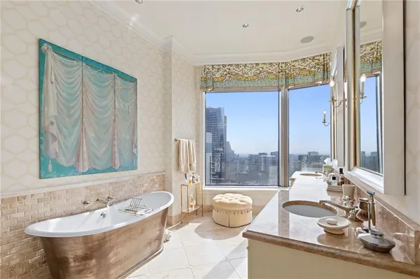 a bathroom with a tub sink and mirror
