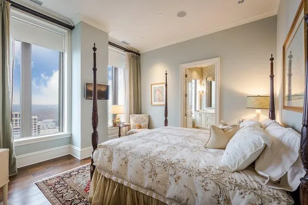 a bed sitting in a bedroom next to a window