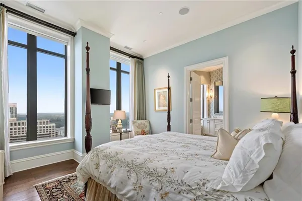 a bedroom with a large bed and a window