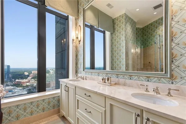a bathroom with double vanity sinks and a mirror