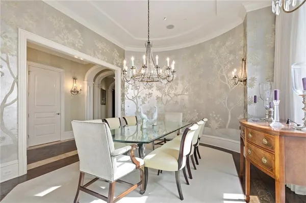 a view of a dining room with furniture and chandelier