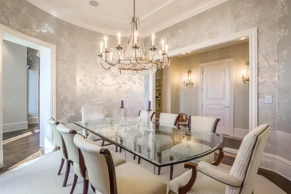 a view of a dining room with furniture and chandelier
